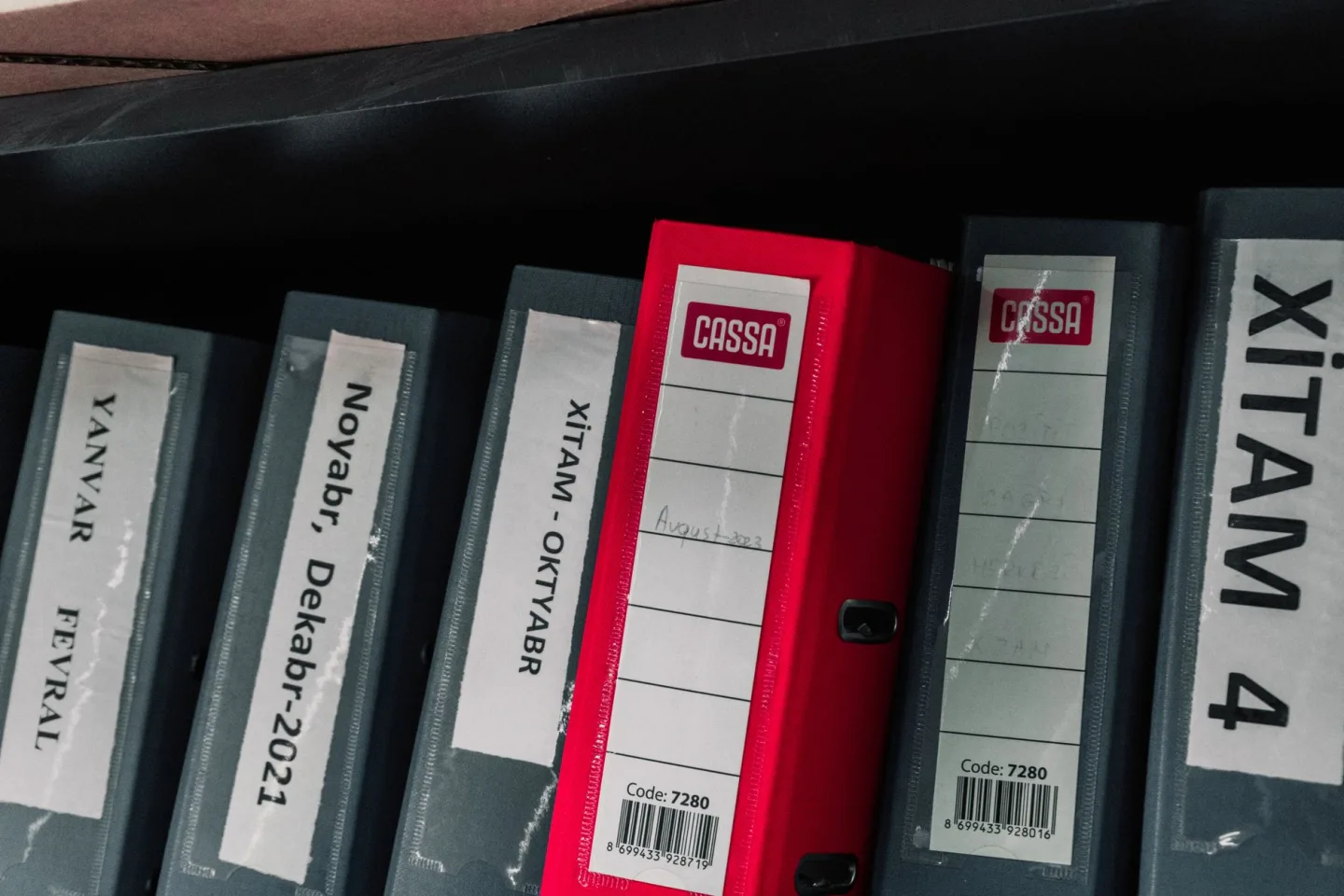 A folder of documents and travel papers on a table