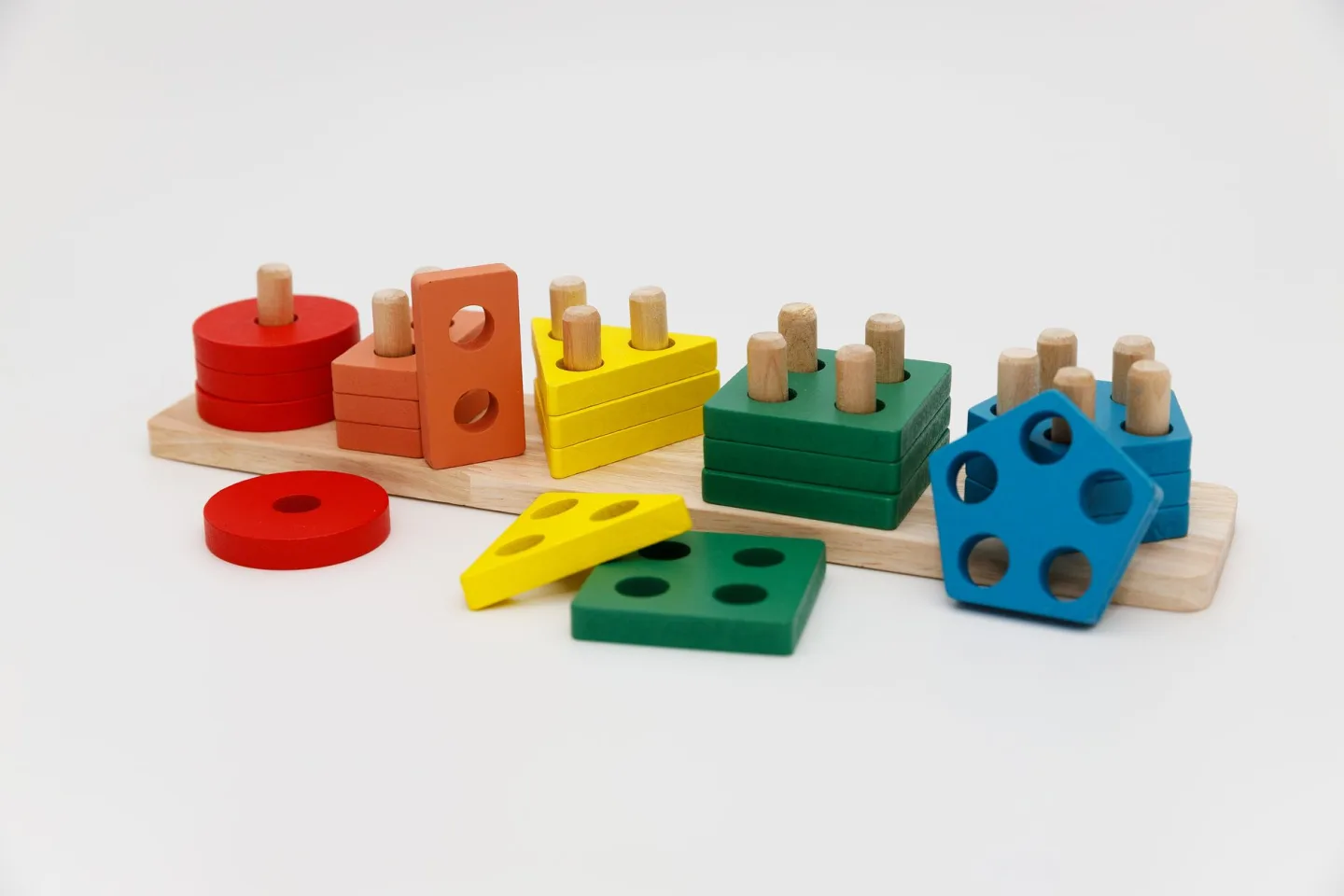 A young child playing with a shape-sorting toy